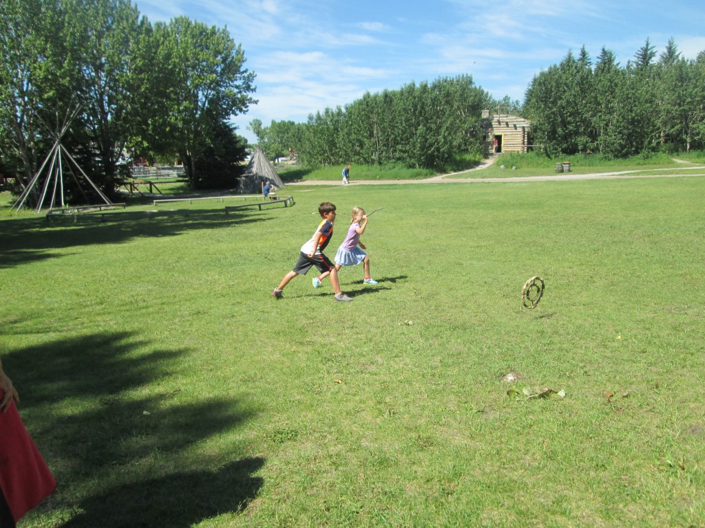 Kane and Kat practicing buffalo hunting.  They have to throw stick through circle.