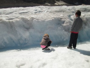 Kat is collecting glacier water. 