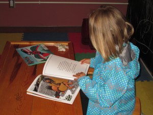 Kat reading a story at center while waiting for tour to start.