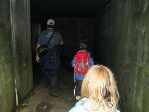 Walking the dark hallway to look at rooms of the fort.