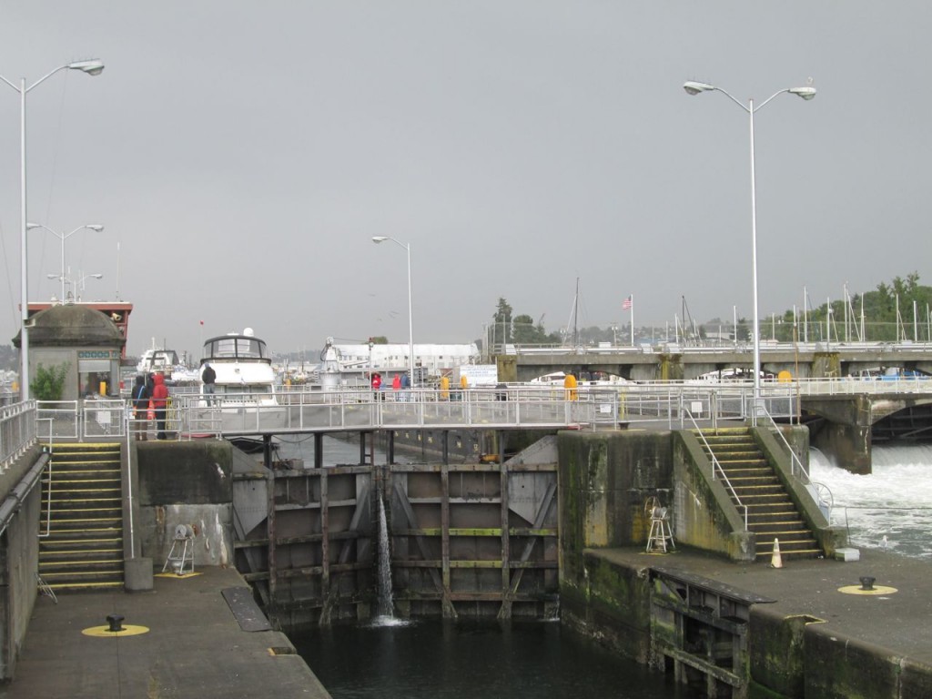 Small (cabin cruiser) pulling in to be lowered and head out to sea.  The little lock leaked more than the big one.