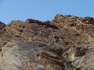 Kane and Kat hiking up a hill together.